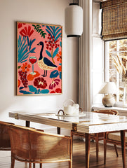 Colourful illustrative wall art of a goose, red wine glass, and abstract botanical elements on a, in a styled room mockup