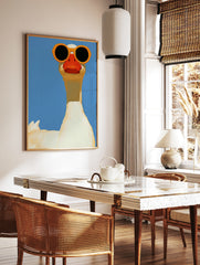 A white goose wearing large orange sunglasses against a solid blue background, illustrative animal, in a styled room mockup