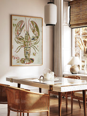 Illustrative lobster art print in olive green, reddish-pink, and white on a textured off-white, in a styled room mockup