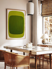 Green abstract wall art print with dark green inner rectangle and lime green outer border on white, in a styled room mockup