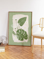 Green botanical wall art featuring white daisies with yellow centers and dark green monstera leaves on a light beige background. - Image 2