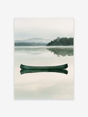 Green canoe floating on a calm, misty lake with a mountain and forest background in a watercolour style art print