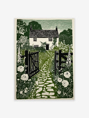 Green linocut print of a British cottage garden with open gate, cobbled path, foxgloves, and roses