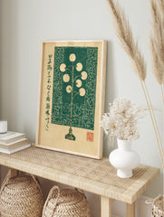 Green floor lamp illustration in woodblock style with spherical lights and Japanese text on a, in an alternate framed mockup