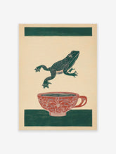 Green frog leaping over a red patterned teacup on a beige background with green stripes. Frog art print.