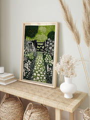 Linocut print of a garden path with white stepping stones leading to a dark wooden gate and, in an alternate framed mockup