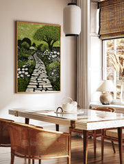 Green and black linocut print of a winding stone garden path surrounded by white flowers and lush, in a styled room mockup