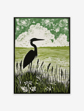 Green linocut style print of a heron in silhouette standing in tall reeds by water, with clouds and birds in the sky
