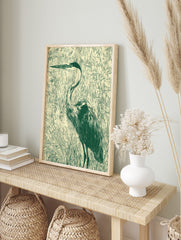 Illustrative green heron bird print standing in marsh grasses on a light beige background in, in an alternate framed mockup