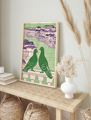 Green pigeon wall art featuring two pigeons on a balcony overlooking a city with purple-roofed buildings - Image 3