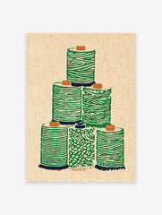 Green thread spool wall art illustration stacked on a light beige background with an illustrative, textured style.