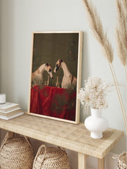 Two greyhounds playing chess by candlelight on a red table, with pine branches, against a, in an alternate framed mockup