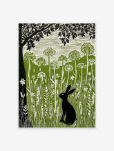 Linocut print of a black hare in a green meadow with tall white wildflowers and a large black tree