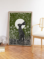 Green linocut print of a black hare sitting in wildflowers under a full moon, capturing a serene nocturnal scene. - Image 2