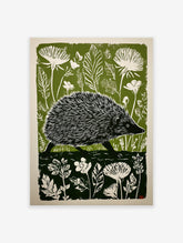 Green and white linocut print of a hedgehog walking through a forest with large leaves and flowers.