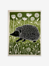 Hedgehog wall art print in green, black, and white, featuring a hedgehog walking through a field of wildflowers.