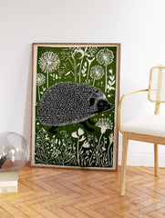 Linocut print of a hedgehog walking through a green and white stylized meadow with dandelion-like flowers. - Image 2