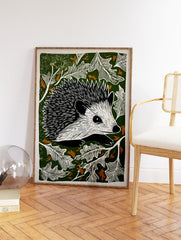 Hedgehog linocut print with black and white hedgehog surrounded by white leaves on a dark green background with brown accents. - Image 2