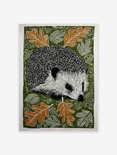 Hedgehog wall art print with black and white hedgehog, brown oak leaves, and white swirling patterns on a dark green background.