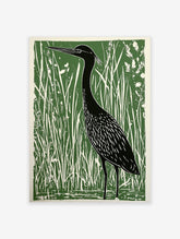 Green and black linocut print featuring a heron bird standing in tall marsh grasses, nature wall art.