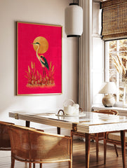 Illustrative heron or crane bird with golden sun and grasses on a hot pink background, portrait, in a styled room mockup