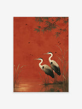 Two herons standing in water with reeds against a red background, with bamboo leaves and small birds flying.