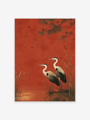 Two herons standing in water with reeds against a red background, with bamboo leaves and small birds flying.