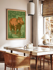 Illustrative hippo standing in water with green reeds, orange and green palette, block print style, in a styled room mockup
