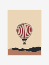 Illustrative red and cream hot air balloon floating above abstract brown and dark grey hills on a beige background