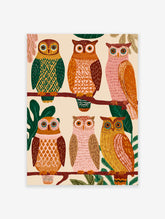 Colorful illustrated owl wall art showing six unique owls with patterned feathers perched on tree branches in a forest setting.