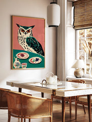 Illustrative owl with orange eyes on teal table with plates and pottery, pink background, folk art, in a styled room mockup