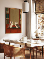 Two illustrative owls on a wooden shelf, flanked by bookshelves with green and Japanese character, in a styled room mockup