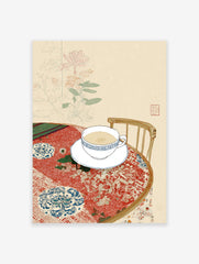 Illustrative wall art of a tea cup and saucer on a patterned red tablecloth with botanical background