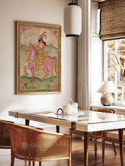 Indian miniature art print of bearded rider in golden attire and red cape on a pink horse, green, in a styled room mockup