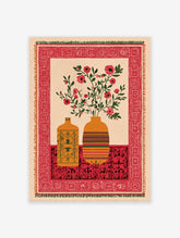 Indian wall art print with two vases of red botanical flowers on a patterned red table, framed by a decorative border.