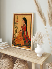 Illustrative Indian woman wall art in red and orange attire with floral botanical elements, in an alternate framed mockup