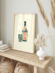 Japanese Awamori liquor bottle and cup woodcut print with orange kanji typography on an, in an alternate framed mockup