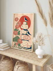 Japanese bird wall art print with two black and white birds, red flowers, green leaves, stacked stones, and a large red sun. - Image 3