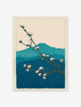 Japanese woodblock print of plum blossoms on a branch with blue mountains in the background. Botanical wall art.