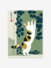 Japanese Ukiyo-e style print of a calico cat stretching against a green background with dark blue leaves.