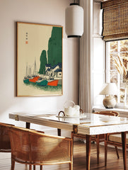 Japanese coastal village wall art with fishing boats, green cliffs, and blue-roofed houses in, in a styled room mockup