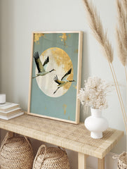 Japanese crane wall art with two birds in flight against a large textured gold sun on a pale, in an alternate framed mockup