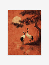 Japanese crane wall art featuring two cranes by water under a pine tree and a large red moon in an orange sky.