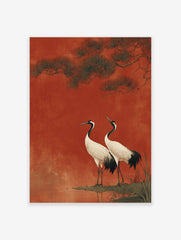 Two Japanese cranes with white bodies and black necks standing by water under pine branches against a textured red background.