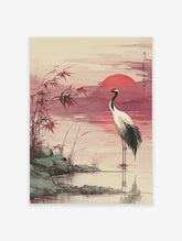 Japanese Red-crowned Crane Wall Art in water at sunset with a red sun, reeds, and rocks in a traditional watercolor style.