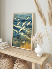 Japanese Red-crowned cranes flying over blue ocean waves with gold outlines and golden reeds, in an alternate framed mockup