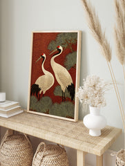 Two Japanese Red-crowned Cranes with black and white plumage, red crowns, against a red, in an alternate framed mockup