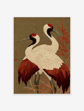 Two red-crowned Japanese cranes with white, red, and black plumage standing in red foliage against a green wave-patterned