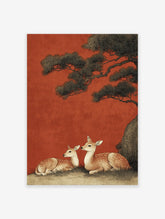 Japanese deer wall art print showing two spotted deer resting under a dark pine tree against a vibrant red background.