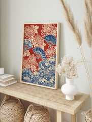 Japanese-style print with red background, blue folding fans, and cream-coloured chrysanthemum, in an alternate framed mockup